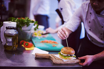 Image showing chef finishing burger