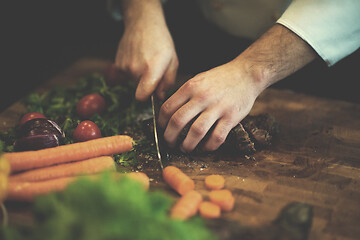 Image showing closeup of Chef hands preparing beef steak