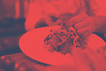 Image showing cook chef decorating garnishing prepared meal