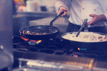 Image showing chef preparing food, frying in wok pan