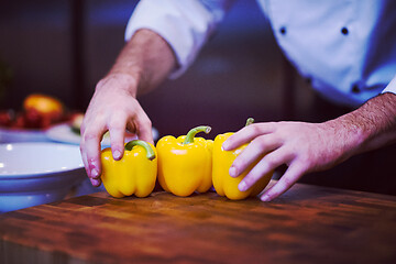 Image showing chef holding fresh peppers