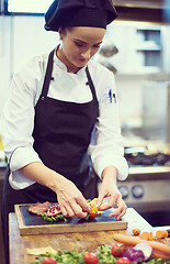 Image showing female Chef preparing beef steak