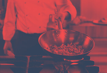 Image showing chef flipping vegetables in wok