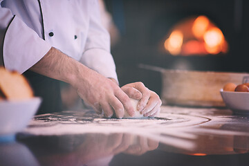 Image showing chef hands preparing dough for pizza