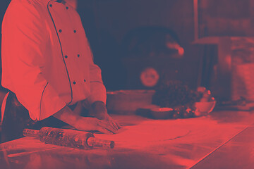 Image showing chef preparing dough for pizza