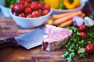 Image showing Juicy slice of raw steak on wooden table