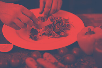 Image showing chef serving vegetable salad