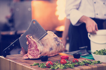 Image showing chef cutting big piece of beef