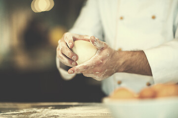 Image showing chef hands preparing dough for pizza