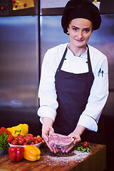 Image showing Chef holding juicy slice of raw steak