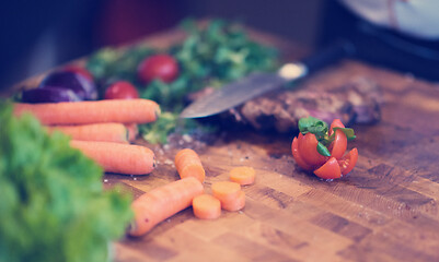 Image showing Juicy slices of grilled steak on wooden board