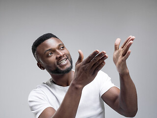 Image showing African american man excited about watching tv.