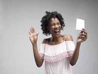 Image showing Young woman with a surprised expression won a bet