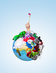 Image showing A globe of the earth with trash over white background, the concept of ecology problem