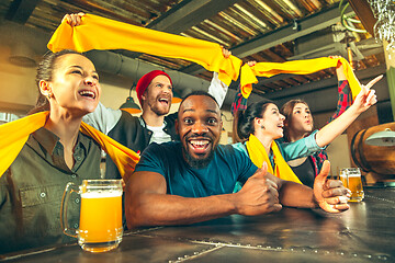 Image showing Sport, people, leisure, friendship and entertainment concept - happy football fans or male friends drinking beer and celebrating victory at bar or pub