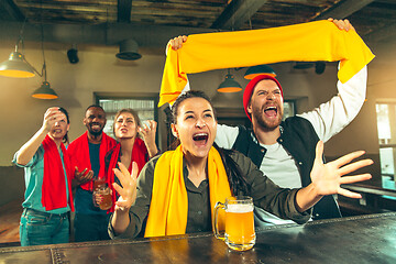 Image showing Sport, people, leisure, friendship and entertainment concept - happy football fans or male friends drinking beer and celebrating victory at bar or pub