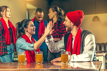 Image showing Sport, people, leisure, friendship and entertainment concept - happy football fans or male friends drinking beer and celebrating victory at bar or pub