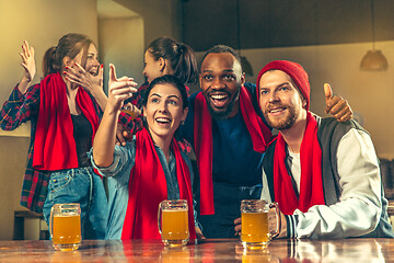 Image showing Sport, people, leisure, friendship and entertainment concept - happy football fans or male friends drinking beer and celebrating victory at bar or pub