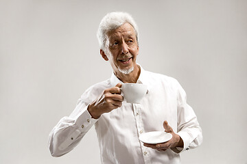 Image showing old age, drink and people concept - happy senior man with cup of tea at home