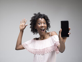 Image showing Portrait of a confident casual afro girl showing blank screen mobile phone