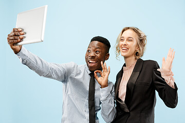 Image showing Concept of partnership in business. Young man and woman standing at studio