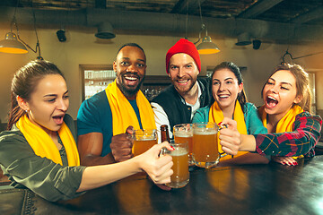 Image showing Sport, people, leisure, friendship and entertainment concept - happy football fans or male friends drinking beer and celebrating victory at bar or pub