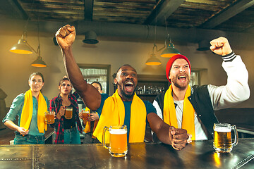 Image showing Sport, people, leisure, friendship and entertainment concept - happy football fans or male friends drinking beer and celebrating victory at bar or pub