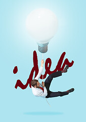 Image showing Concept of a new idea. A man going with a lamp