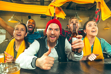 Image showing Sport, people, leisure, friendship and entertainment concept - happy football fans or male friends drinking beer and celebrating victory at bar or pub