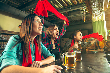 Image showing Sport, people, leisure, friendship and entertainment concept - happy football fans or female friends drinking beer and celebrating victory at bar or pub