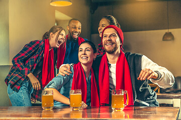 Image showing Sport, people, leisure, friendship and entertainment concept - happy football fans or male friends drinking beer and celebrating victory at bar or pub