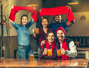 Image showing Sport, people, leisure, friendship and entertainment concept - happy football fans or male friends drinking beer and celebrating victory at bar or pub