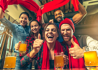 Image showing Sport, people, leisure, friendship and entertainment concept - happy football fans or male friends drinking beer and celebrating victory at bar or pub