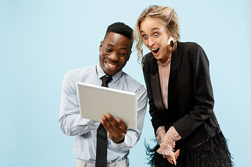 Image showing Concept of partnership in business. Young man and woman standing at studio