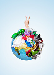 Image showing A globe of the earth with trash over white background, the concept of ecology problem