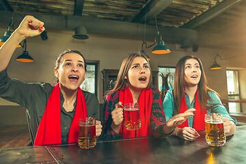 Image showing Sport, people, leisure, friendship and entertainment concept - happy football fans or female friends drinking beer and celebrating victory at bar or pub