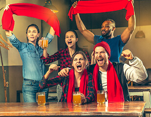 Image showing Sport, people, leisure, friendship and entertainment concept - happy football fans or male friends drinking beer and celebrating victory at bar or pub