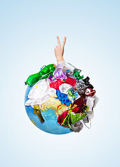 Image showing A globe of the earth with trash over white background, the concept of ecology problem