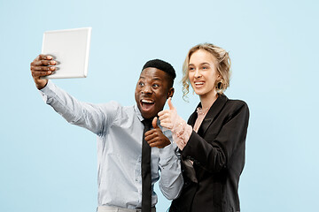 Image showing Concept of partnership in business. Young man and woman standing at studio