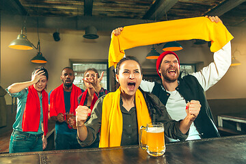 Image showing Sport, people, leisure, friendship and entertainment concept - happy football fans or male friends drinking beer and celebrating victory at bar or pub