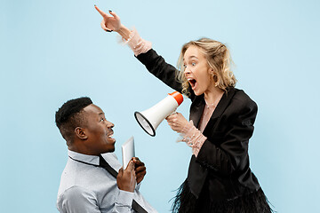 Image showing angry businesswoman and colleague in the office.