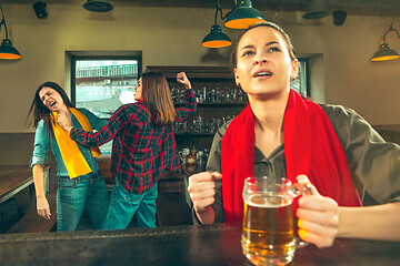 Image showing Sport, people, leisure, friendship and entertainment concept - happy football fans or female friends drinking beer and celebrating victory at bar or pub