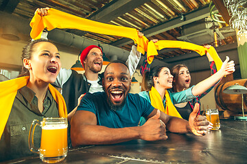 Image showing Sport, people, leisure, friendship and entertainment concept - happy football fans or male friends drinking beer and celebrating victory at bar or pub