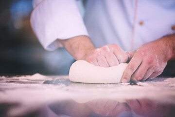 Image showing chef hands preparing dough for pizza