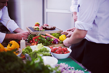 Image showing team cooks and chefs preparing meal