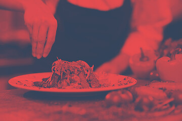 Image showing cook chef decorating garnishing prepared meal