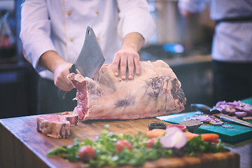 Image showing chef cutting big piece of beef