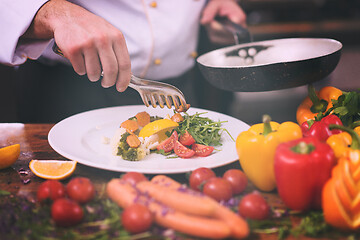 Image showing chef serving vegetable salad