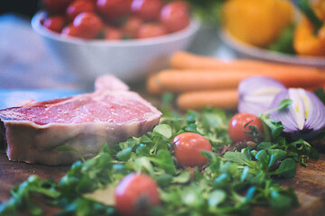 Image showing Juicy slice of raw steak on wooden table