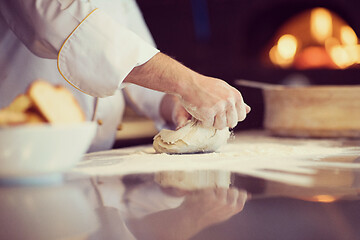 Image showing chef hands preparing dough for pizza